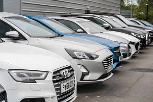 Auto trader cars for sale near me—row of modern sedans and SUVs parked at dealership lot.