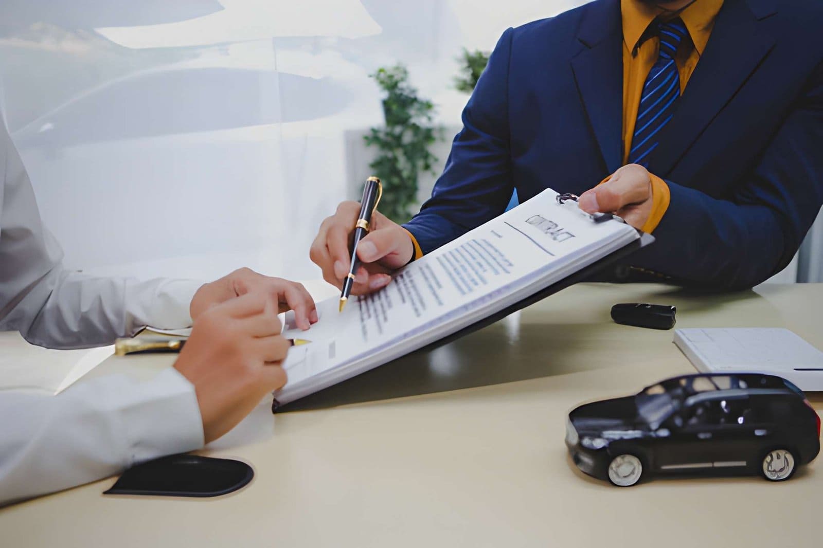 Buy here pay here Sarasota no credit check contract signing with car model and keys on desk