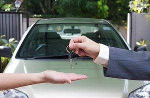 Used car dealers Venice FL key handover showing trust and transaction between seller and buyer