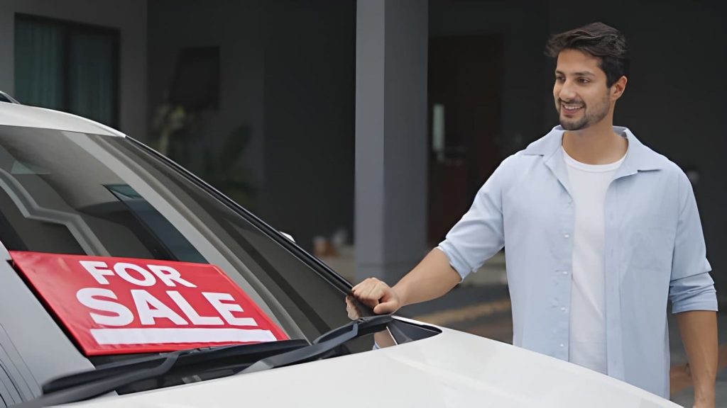 Auto dealers Boca Raton Florida showcasing white car with for sale sign outdoors.